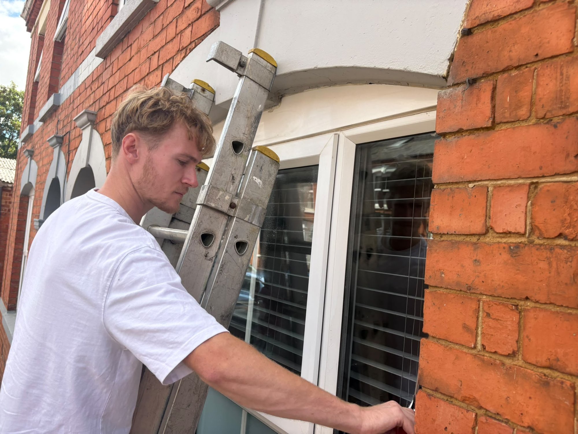 Sean cleaning a bay window