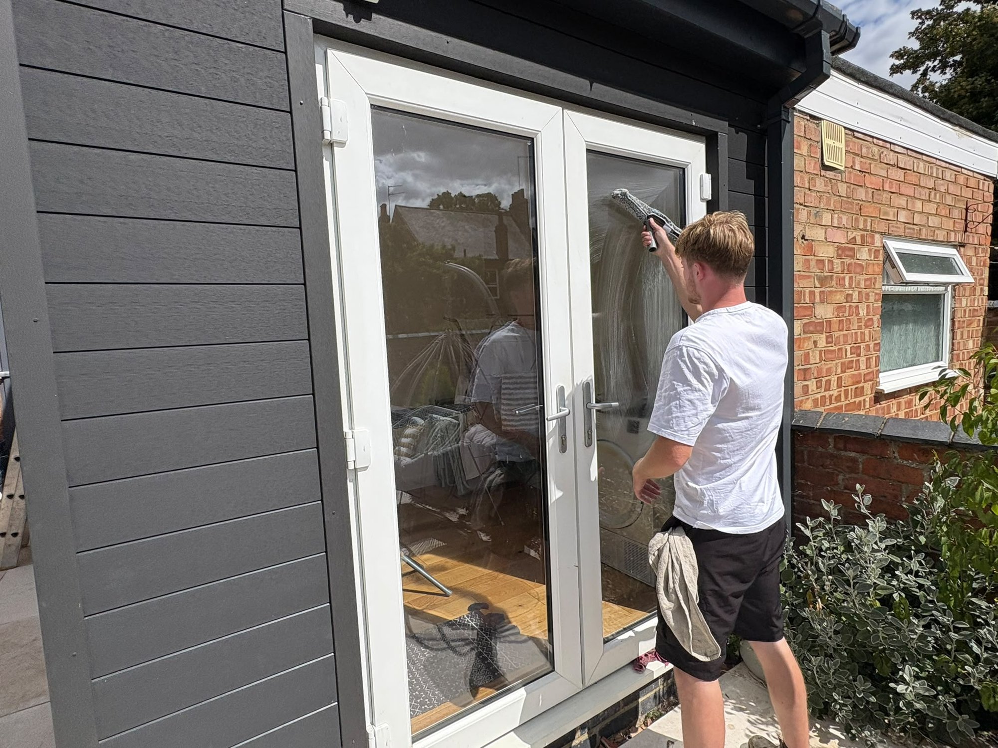 French doors being cleaned by hand