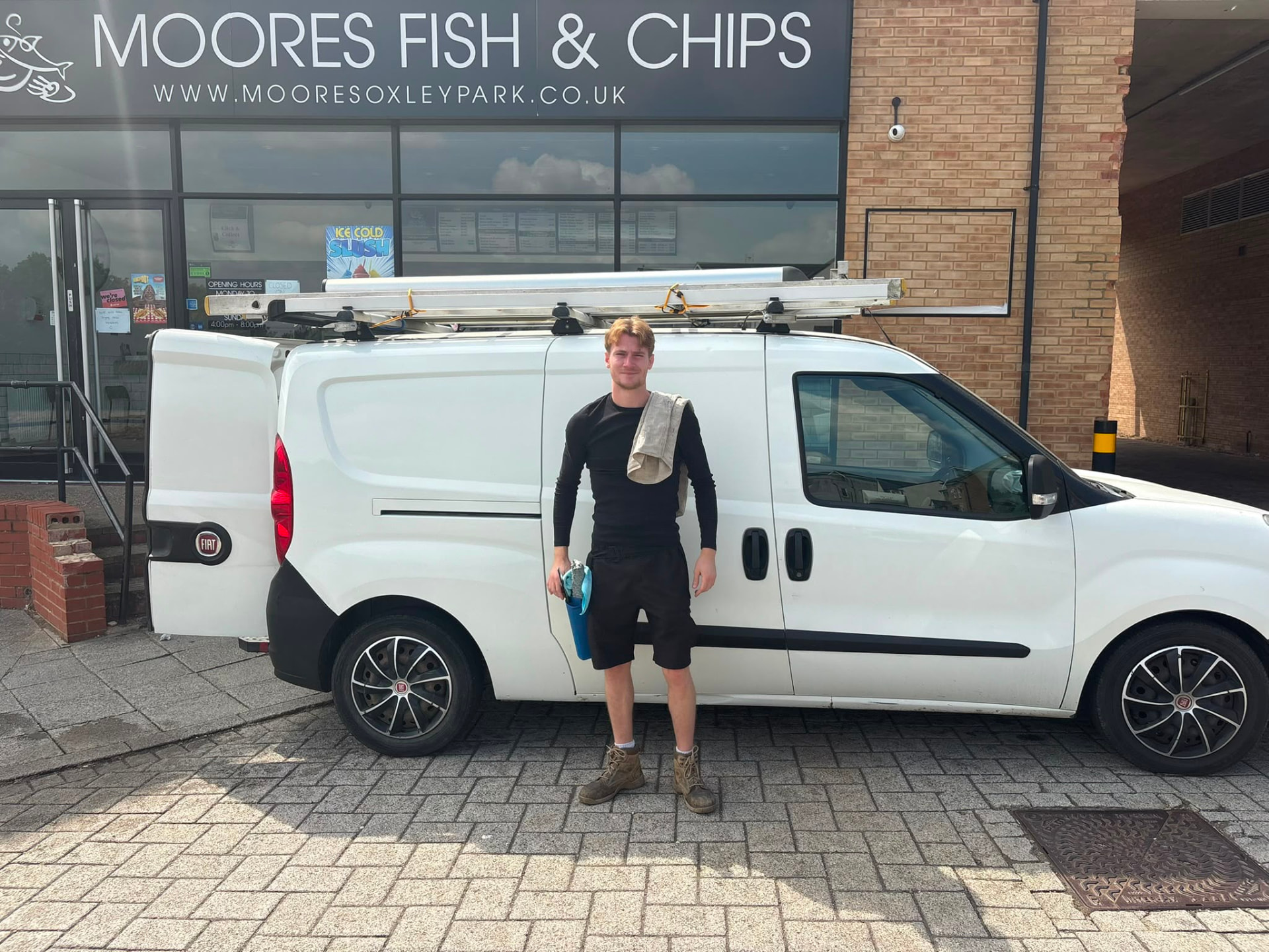 Sean Moran with the Windows and Moore van outside a Milton Keynes shopfront
