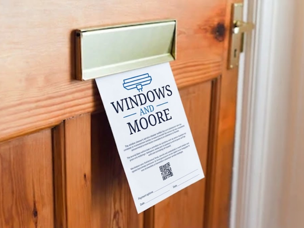 A Windows and Moore card posted through a front door letterbox