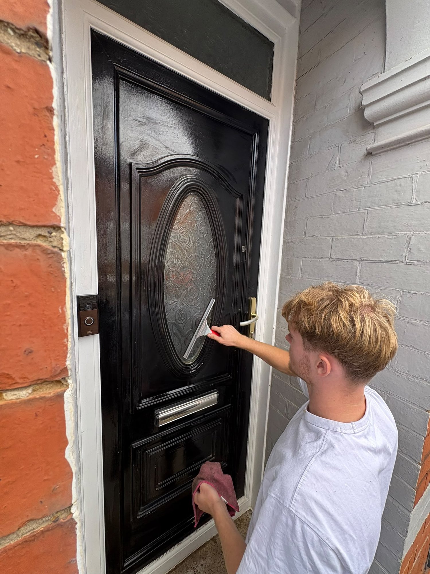 Front door glass being squeegeed